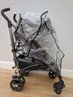 A stroller with removable rain-cover fitted.
