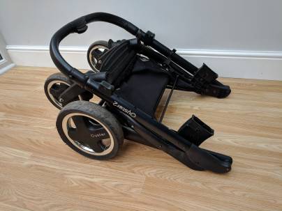 The frame of a drop fold stroller (without a carriage)