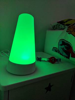 A humidifier nightlight on a bedside table