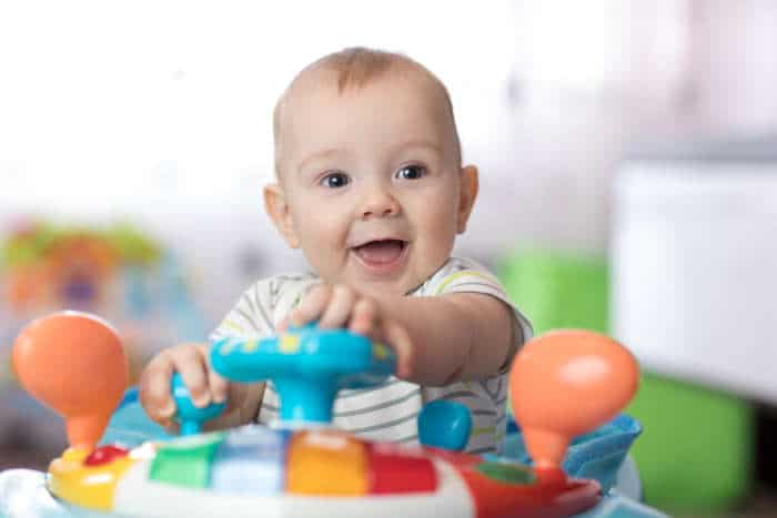 Baby sitting in activity center