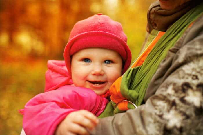 A happy baby in a sling