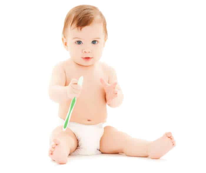 Curious baby with a toothbrush