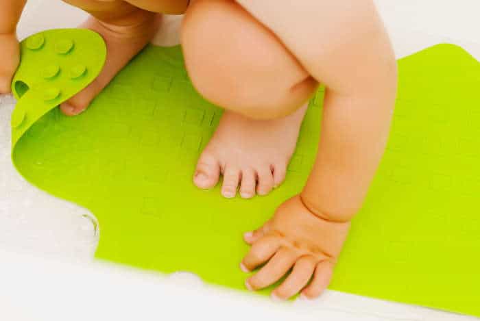 Baby feet in on anti slip rubber mat for bathroom