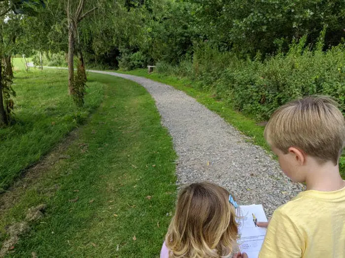 2 children reading a puzzle trail bookket