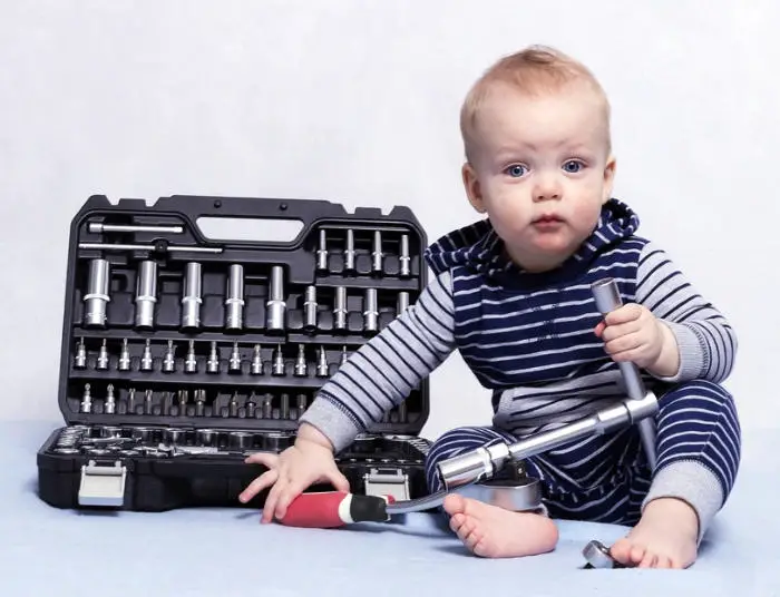 Toddler with adult tool set