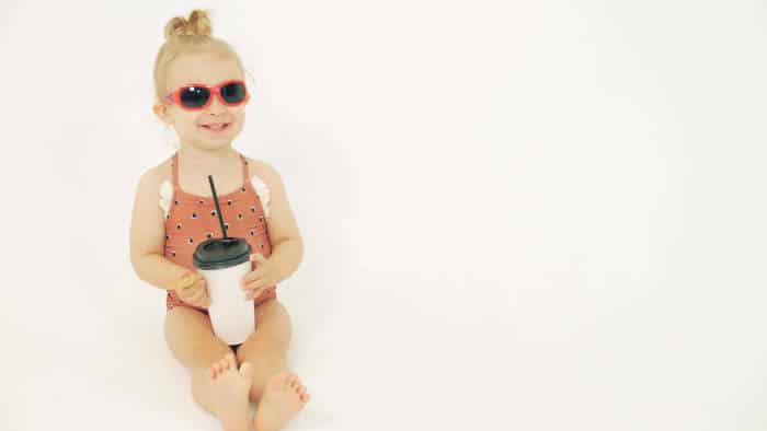 Baby girl with paper straw cup