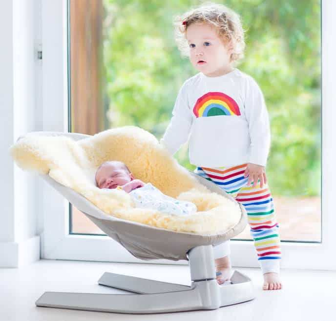 infant-in-baby-swing-with-sibling