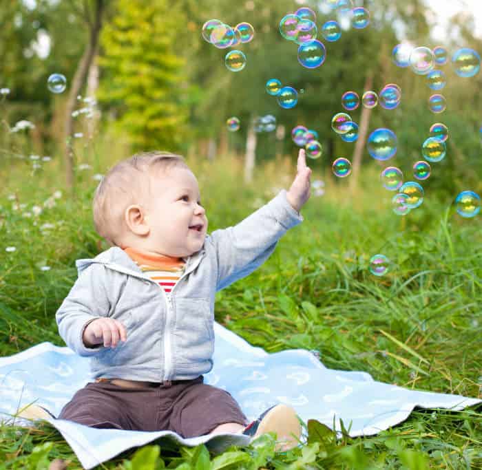 baby boy playing with bubbles