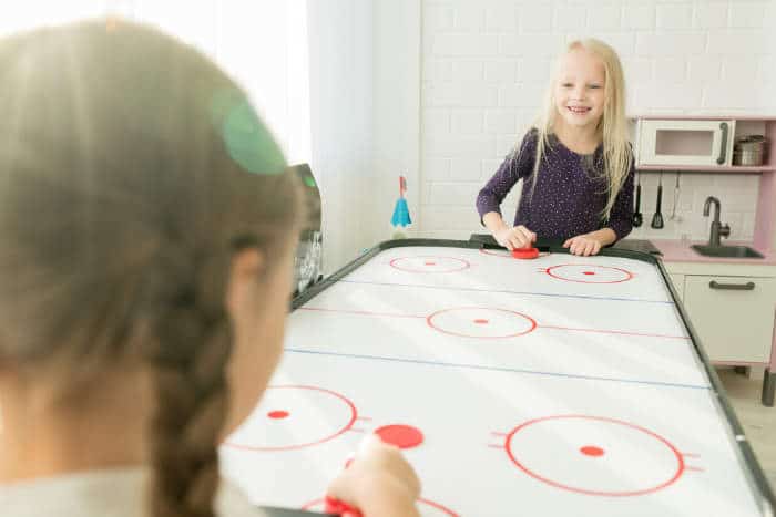 Girls playing air hockey