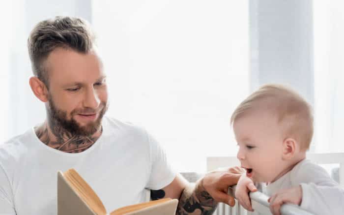 dad reading a book with baby