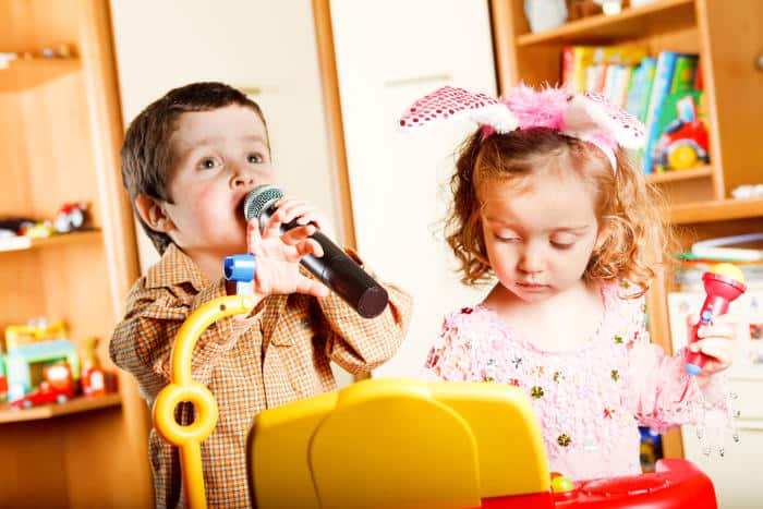 young kids playing with karaoke machines