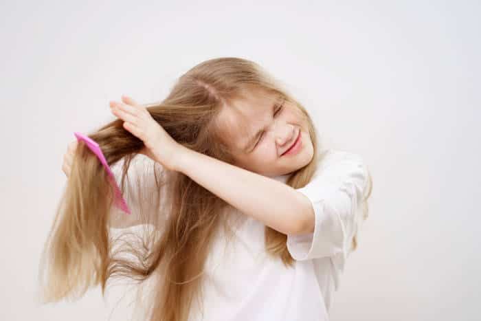 girl combing tangled hair